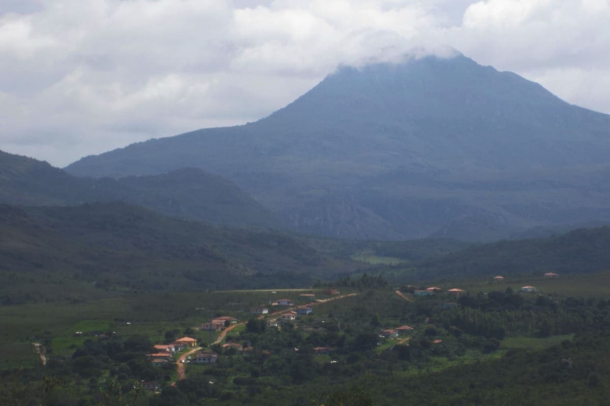 Pico do Itambé com o topo coberto por nuvens, visto da chegada ao povoado de Capivari, no Serro
